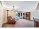 Living room with a brown leather chair and a window at 9745 Derby Way, Parker, CO 80134