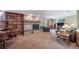 Inviting living room boasts a stone fireplace, built-in bookshelves, and a cozy seating area at 9745 Derby Way, Parker, CO 80134