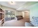 Cozy living room featuring a sliding glass door with view to the exterior, comfortable sofa, and neutral carpet at 9745 Derby Way, Parker, CO 80134