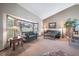 Cozy living room with large windows, neutral tones, and comfortable seating at 9745 Derby Way, Parker, CO 80134