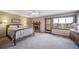 Spacious bedroom with a fireplace, ceiling fan, and access to a private balcony at 9745 Derby Way, Parker, CO 80134