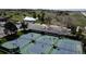 Aerial shot of outdoor tennis courts and parking, set in a golf community with green surroundings at 9745 Derby Way, Parker, CO 80134