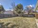 Spacious fenced backyard with mature trees, perfect for outdoor activities and relaxation at 11002 E Ohio Pl, Aurora, CO 80012