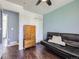 Comfortable bedroom with a black leather futon, ceiling fan, closet and dresser storage at 11002 E Ohio Pl, Aurora, CO 80012