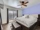 Bright bedroom featuring a king-size bed, ceiling fan, and access to a private outdoor deck at 11002 E Ohio Pl, Aurora, CO 80012