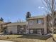 Charming split-level home with a brick and tan exterior, attached two-car garage, basketball hoop and winter foliage at 11002 E Ohio Pl, Aurora, CO 80012