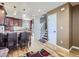 Open kitchen and staircase featuring wood cabinets, center island with seating, and hardwood floors at 11002 E Ohio Pl, Aurora, CO 80012