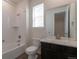 Bright bathroom with white subway tile, marble countertop, and tub with shower at 24314 E Ford Ave, Aurora, CO 80018