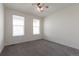 This bedroom features plush carpeting, two windows, and a ceiling fan at 24314 E Ford Ave, Aurora, CO 80018