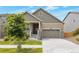 Charming two-story home with a well-manicured front yard, a covered porch and a two car garage at 24314 E Ford Ave, Aurora, CO 80018
