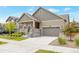 Well-maintained two-story home with a tidy front yard and attached two-car garage on a sunny day at 24314 E Ford Ave, Aurora, CO 80018