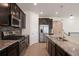 Modern kitchen featuring stainless steel appliances, dark cabinetry and an island with pendant lighting at 24314 E Ford Ave, Aurora, CO 80018
