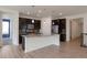 Well-lit kitchen with stainless steel appliances, dark cabinetry and an island with pendant lighting at 24314 E Ford Ave, Aurora, CO 80018