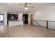 Open-concept living area with hardwood floors, ceiling fan, and a kitchen island in the background at 24314 E Ford Ave, Aurora, CO 80018