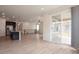 Bright living area with hardwood floors leading to a screened deck, adjacent to a modern kitchen at 24314 E Ford Ave, Aurora, CO 80018