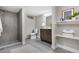 Basement bathroom with walk-in shower, floating shelves, and dark vanity at 6443 Reed Ct, Arvada, CO 80003