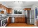 Kitchen boasts stainless steel appliances and wood cabinets at 4122 S Andes Way, Aurora, CO 80013