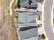 Aerial view of the roof and landscaping of the home, including a concrete driveway and walkway at 8985 Chalk Creek Pl, Littleton, CO 80125