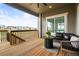 Covered outdoor deck with comfortable seating, a fire pit, and a view of the neighborhood at 8985 Chalk Creek Pl, Littleton, CO 80125
