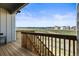 Outdoor wooden deck with railing offering scenic views of the expansive land and neighboring houses at 8985 Chalk Creek Pl, Littleton, CO 80125