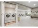 Finished basement with a convenient laundry area, neutral decor, and an open layout perfect for recreation or entertainment at 8985 Chalk Creek Pl, Littleton, CO 80125