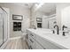 Bright bathroom with double sink vanity, quartz counters, modern fixtures and glass enclosed shower at 8985 Chalk Creek Pl, Littleton, CO 80125