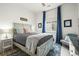 A cozy bedroom features blue curtains, a decorative headboard, and complementary decor at 8985 Chalk Creek Pl, Littleton, CO 80125