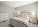 Relaxing bedroom with a stylish wooden bed, soft carpeting, and ample natural light, creating a serene retreat at 8985 Chalk Creek Pl, Littleton, CO 80125