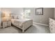 Comfortable bedroom featuring a decorative wooden bed frame, a cozy carpet, and a window for natural light at 8985 Chalk Creek Pl, Littleton, CO 80125