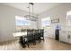 Bright dining room with large windows providing plenty of natural light and views of the neighborhood at 8985 Chalk Creek Pl, Littleton, CO 80125