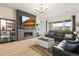 Inviting living room with a stylish fireplace, stone accent wall, and an abundance of natural light at 8985 Chalk Creek Pl, Littleton, CO 80125