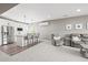 Bright lower level area with stainless steel appliances, kitchen island, seating, and living space at 8985 Chalk Creek Pl, Littleton, CO 80125