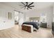 Relaxing main bedroom with a sliding barn door into the ensuite bathroom and scenic backyard views at 8985 Chalk Creek Pl, Littleton, CO 80125