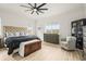 Tranquil main bedroom featuring large windows, neutral decor, and a decorative ceiling fan at 8985 Chalk Creek Pl, Littleton, CO 80125
