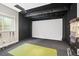 Home theater featuring a large screen, comfortable seating, and a popcorn machine for a cinematic experience at 8985 Chalk Creek Pl, Littleton, CO 80125