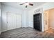 Bright bedroom with sliding closet doors, ceiling fan, and wood-look floors, creating a modern and comfortable space at 18726 E Yale Cir # D, Aurora, CO 80013