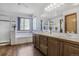 Bright bathroom with double sink, bathtub, shower stall, and a large mirror and window at 5457 S Valdai St, Aurora, CO 80015