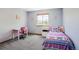 Cozy bedroom featuring a twin bed, window, desk, and neutral-toned walls at 5457 S Valdai St, Aurora, CO 80015