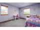 Comfortable bedroom featuring ample natural light and a cheerful accent wall at 5457 S Valdai St, Aurora, CO 80015