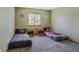 Neutral-toned bedroom featuring twin beds, window, and carpeted floors at 5457 S Valdai St, Aurora, CO 80015