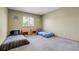 Bedroom featuring two twin beds, a window for natural light, and neutral-toned walls at 5457 S Valdai St, Aurora, CO 80015