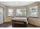 Bright breakfast nook with a table, bench seating, and multiple windows overlooking the yard at 5457 S Valdai St, Aurora, CO 80015