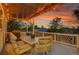 Enjoy outdoor dining on this covered deck featuring a dining table and chairs with string lights above at 5457 S Valdai St, Aurora, CO 80015
