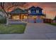 Charming two-story home featuring a covered porch and a two-car garage with a long driveway at 5457 S Valdai St, Aurora, CO 80015