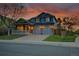 Beautiful two-story home with a covered front porch, attached two-car garage, and manicured lawn at 5457 S Valdai St, Aurora, CO 80015