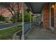 Inviting front porch with brick accents, hanging flower baskets, and comfortable seating at 5457 S Valdai St, Aurora, CO 80015
