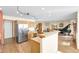 Open kitchen layout featuring wood flooring, stainless appliances, and a seamless flow to the living area at 5457 S Valdai St, Aurora, CO 80015