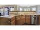 Open kitchen featuring oak cabinetry, tile countertops, and stainless steel appliances at 5457 S Valdai St, Aurora, CO 80015