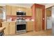 Efficient kitchen layout including modern appliances, ample counter space, and a convenient laundry area at 5457 S Valdai St, Aurora, CO 80015