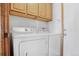 Efficient laundry area featuring a washer and dryer with convenient overhead cabinet storage at 5457 S Valdai St, Aurora, CO 80015